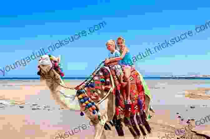 A Young Child Riding A Camel Through The Desert. Flying Camels And Tiger Mothers